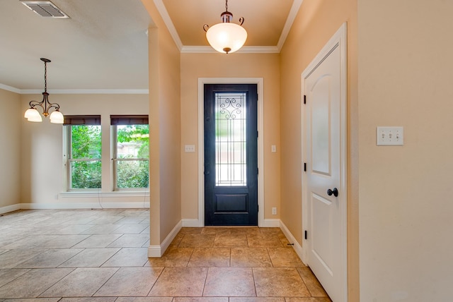 entrance foyer with baseboards, visible vents, ornamental molding, and a notable chandelier