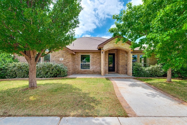 ranch-style home with a front lawn and brick siding