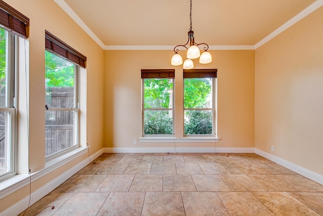 spare room featuring an inviting chandelier, ornamental molding, and baseboards