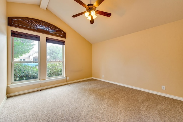 carpeted spare room featuring lofted ceiling with beams, a ceiling fan, and baseboards