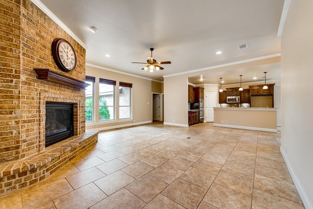 unfurnished living room featuring visible vents, baseboards, ornamental molding, a fireplace, and a ceiling fan