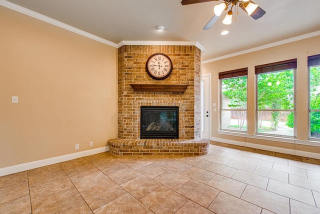 unfurnished living room with a brick fireplace, ceiling fan, baseboards, ornamental molding, and tile patterned flooring