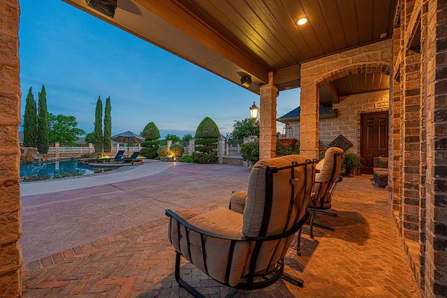 view of patio / terrace featuring an outdoor pool and fence