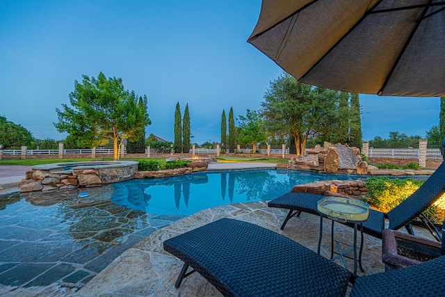 view of swimming pool featuring a fenced backyard, a patio area, and a pool with connected hot tub