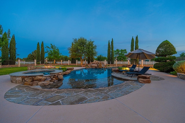 view of swimming pool with fence, a patio, and a pool with connected hot tub