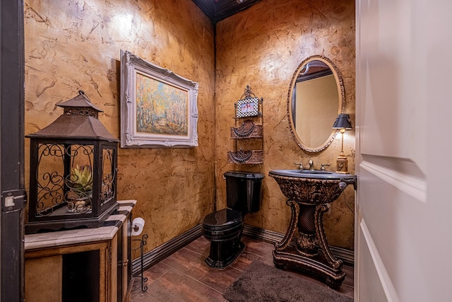 half bathroom with wood finished floors and toilet