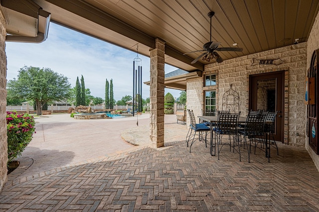 view of patio with a ceiling fan and outdoor dining space