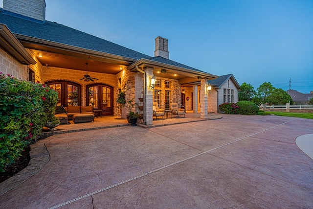 back of house featuring a chimney, outdoor lounge area, ceiling fan, a patio, and fence