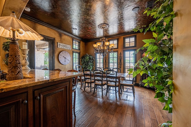 dining room with a chandelier, dark wood-style floors, and an ornate ceiling