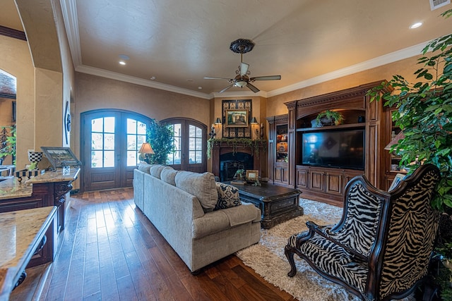 living area featuring french doors, dark wood-style floors, a ceiling fan, a fireplace, and recessed lighting