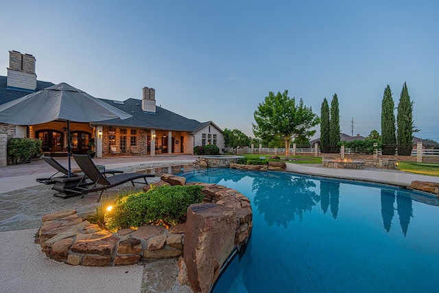 view of pool featuring french doors, a patio area, and fence