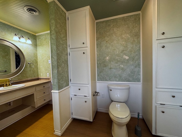 3619 W Wadley Ave, Midland, TX 79707 - bathroom featuring wainscoting, vanity, wood finished floors, and ornamental molding