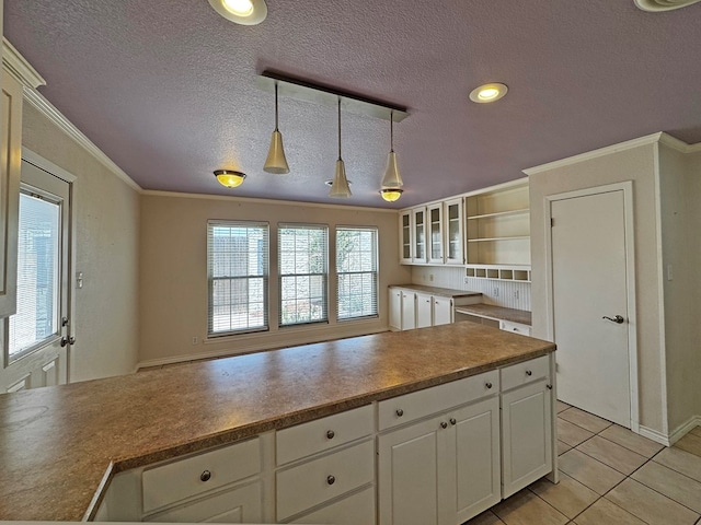 3619 W Wadley Ave, Midland, TX 79707 - kitchen featuring pendant lighting, a textured ceiling, white cabinets, crown molding, and open shelves