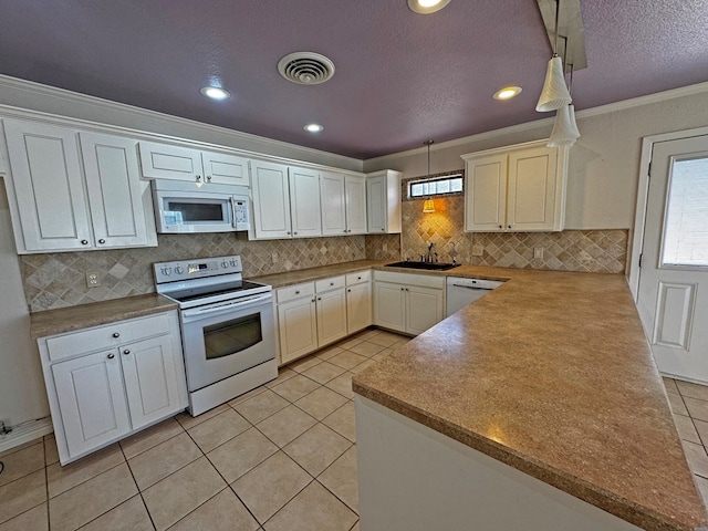 3619 W Wadley Ave, Midland, TX 79707 - kitchen featuring white appliances, ornamental molding, light tile patterned floors, backsplash, and a peninsula