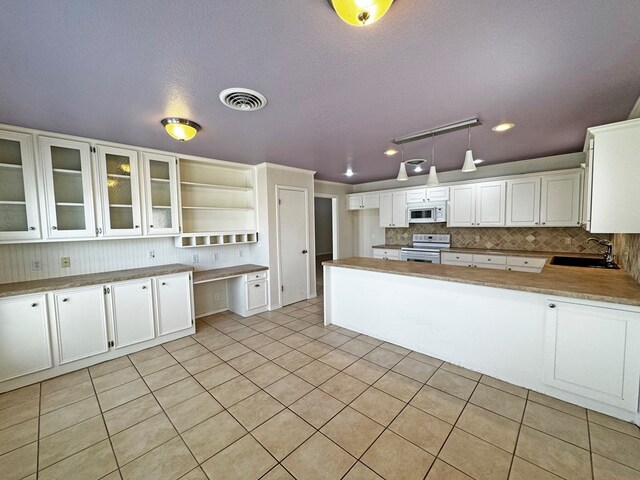 3619 W Wadley Ave, Midland, TX 79707 - kitchen with white appliances, tasteful backsplash, open shelves, light tile patterned floors, and recessed lighting