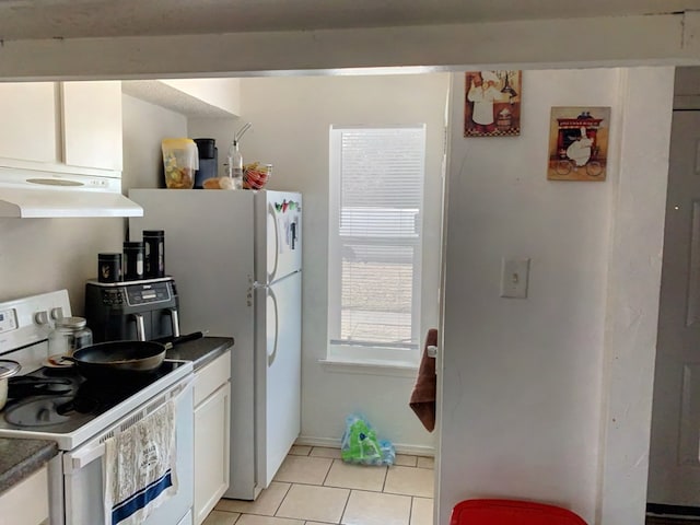 kitchen featuring white cabinetry, light tile patterned floors, and white range with electric cooktop