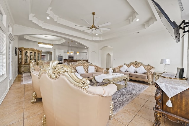 4626 Crockett Ave, Midland, TX 79703 - living area with light tile patterned floors, ceiling fan, arched walkways, and a tray ceiling