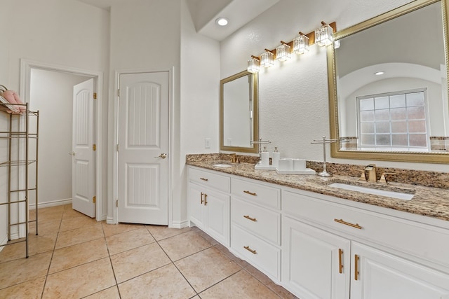 4626 Crockett Ave, Midland, TX 79703 - full bath with double vanity, baseboards, tile patterned flooring, and a sink