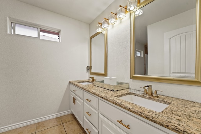 4626 Crockett Ave, Midland, TX 79703 - bathroom with tile patterned flooring, a sink, double vanity, and baseboards