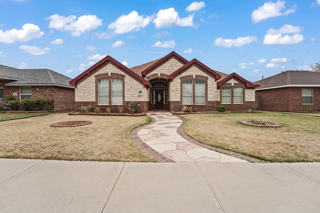 4626 Crockett Ave, Midland, TX 79703 - view of front facade with a front yard, stone siding, and brick siding