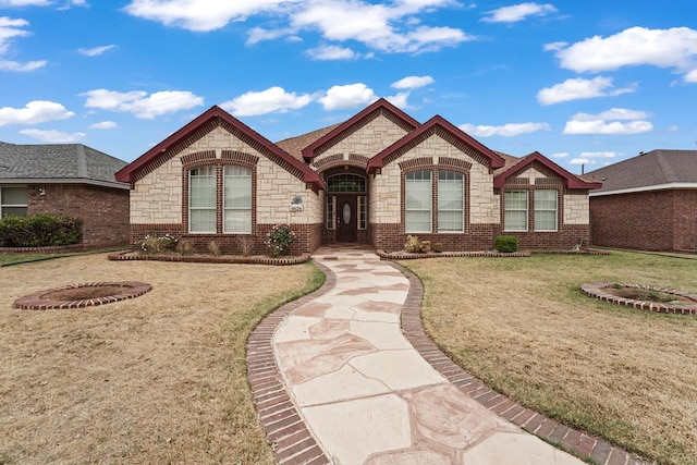 4626 Crockett Ave, Midland, TX 79703 - view of front of house with a front yard, stone siding, and brick siding