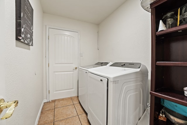 4626 Crockett Ave, Midland, TX 79703 - laundry room featuring light tile patterned floors, separate washer and dryer, laundry area, and baseboards