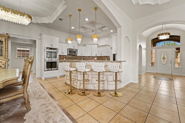 4626 Crockett Ave, Midland, TX 79703 - kitchen featuring light tile patterned floors, stainless steel appliances, backsplash, and arched walkways