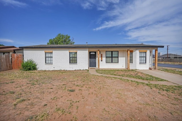 single story home with brick siding and fence