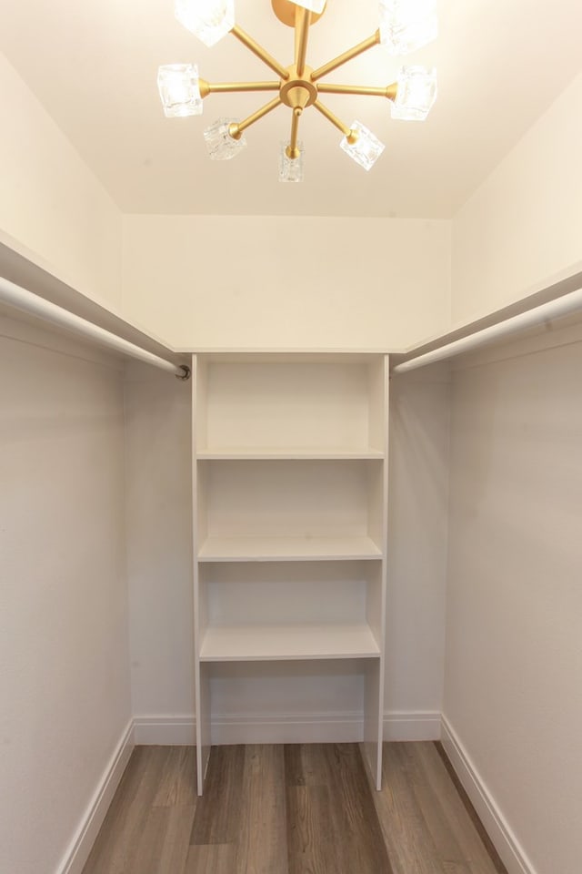 2702 Ann Dr, Big Spring, TX 79720 - spacious closet featuring wood finished floors and a chandelier