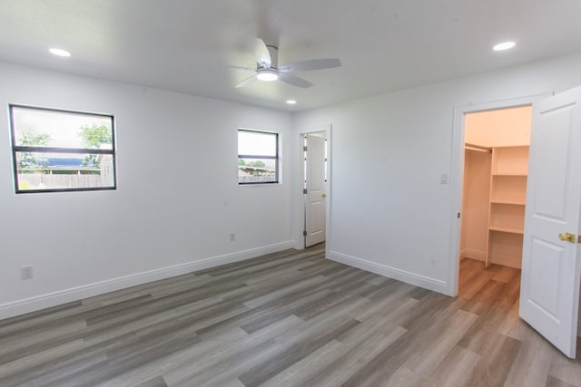 2702 Ann Dr, Big Spring, TX 79720 - unfurnished bedroom featuring a spacious closet, light wood-style flooring, recessed lighting, and ceiling fan