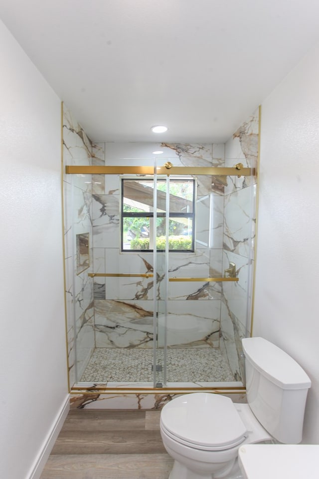 2702 Ann Dr, Big Spring, TX 79720 - bathroom featuring a marble finish shower and wood finished floors