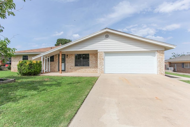 2702 Ann Dr, Big Spring, TX 79720 - ranch-style house featuring concrete driveway, a garage, a front lawn, and brick siding