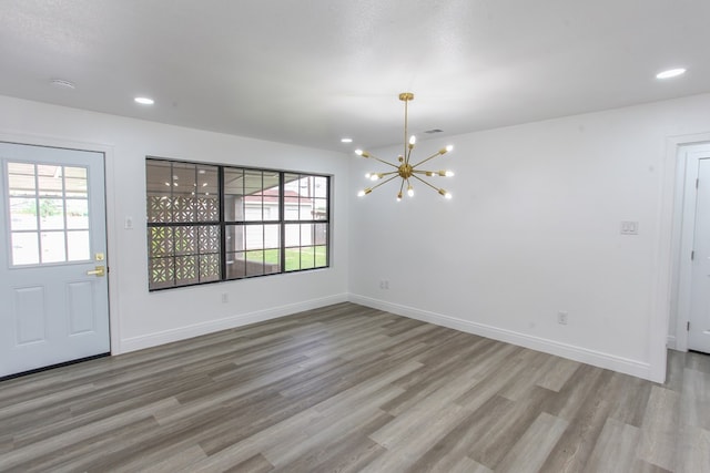 2702 Ann Dr, Big Spring, TX 79720 - unfurnished dining area with a chandelier, wood finished floors, and recessed lighting