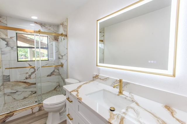 2702 Ann Dr, Big Spring, TX 79720 - bathroom featuring vanity, a marble finish shower, and wood finished floors