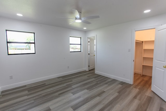 2702 Ann Dr, Big Spring, TX 79720 - unfurnished bedroom with a spacious closet, wood finished floors, recessed lighting, and a ceiling fan
