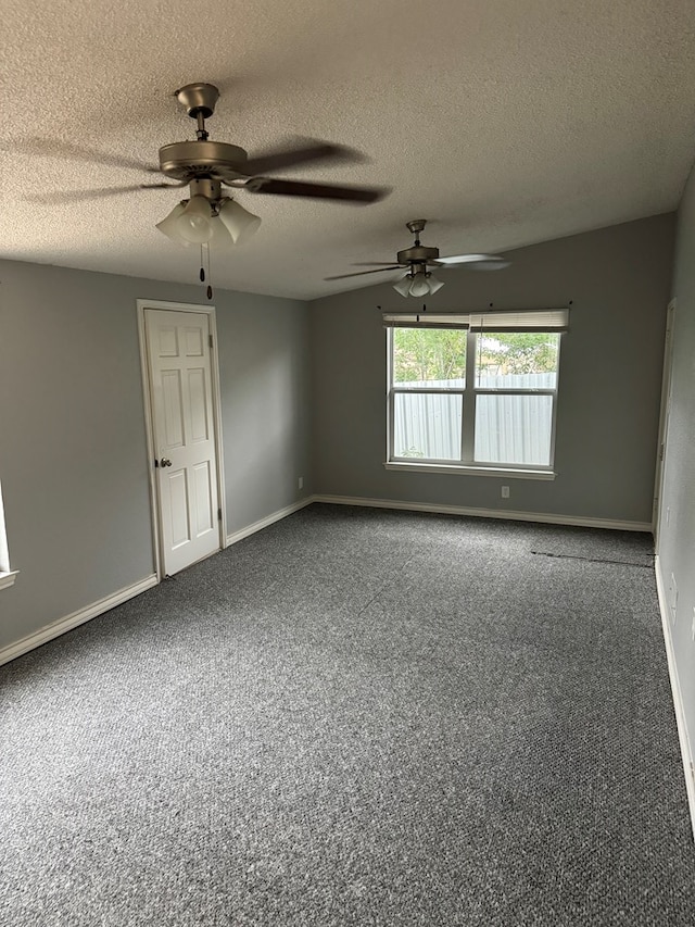 unfurnished room featuring a textured ceiling, ceiling fan, and baseboards
