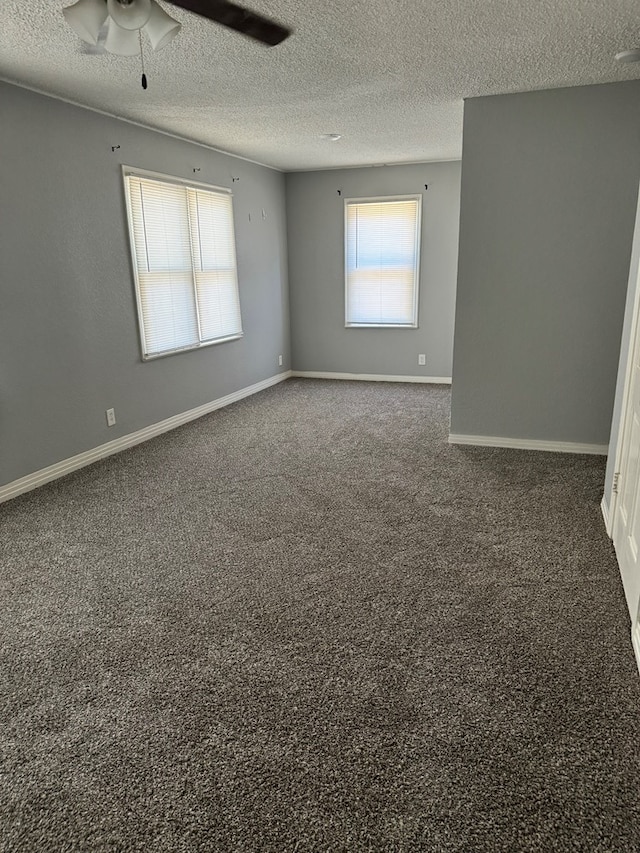 spare room with carpet flooring, a textured ceiling, ceiling fan, and baseboards