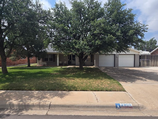 2909 Princeton Ave, Midland, TX 79701 - view of property hidden behind natural elements with driveway, an attached garage, and brick siding