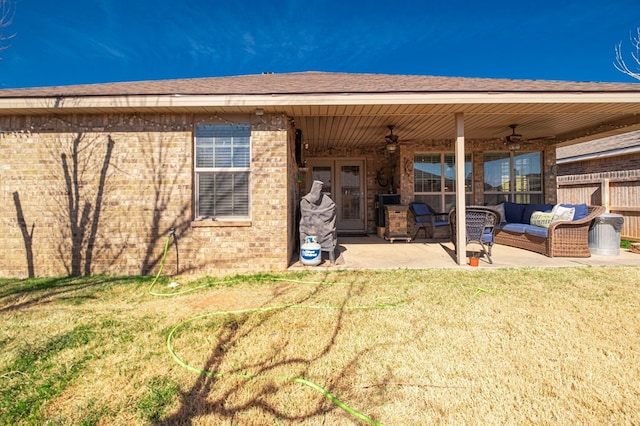 rear view of house with a yard, outdoor lounge area, a patio, and ceiling fan