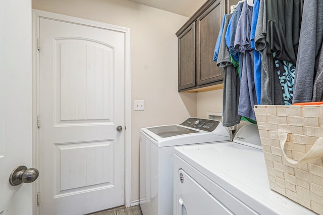 washroom with separate washer and dryer and cabinets