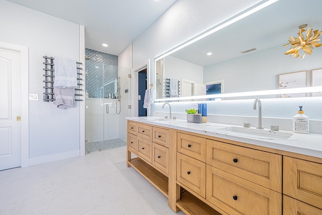 bathroom with double vanity, a stall shower, a sink, and visible vents