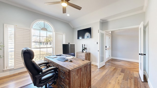 office space featuring light wood-type flooring, vaulted ceiling, crown molding, and baseboards