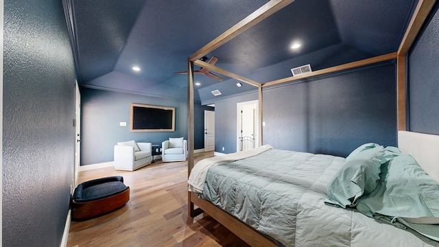 bedroom featuring lofted ceiling, recessed lighting, visible vents, wood finished floors, and baseboards