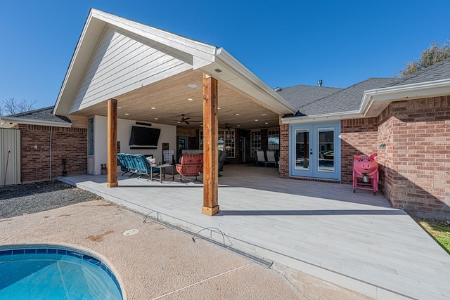 view of pool with ceiling fan and french doors