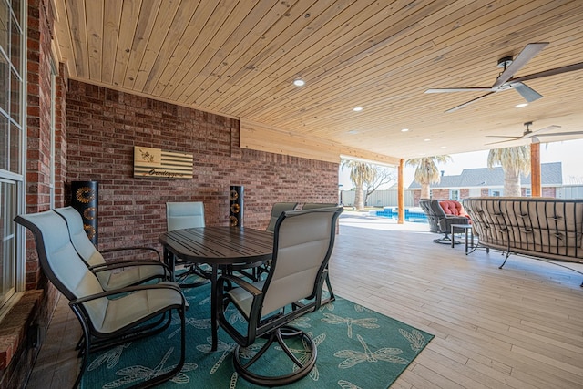 wooden terrace with a fenced in pool, outdoor dining area, and a ceiling fan