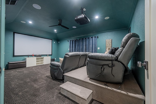 cinema room featuring a textured wall, carpet floors, a ceiling fan, vaulted ceiling, and crown molding