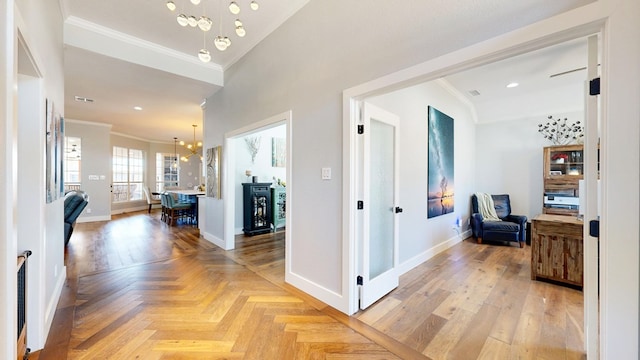 corridor with baseboards, recessed lighting, a notable chandelier, and crown molding