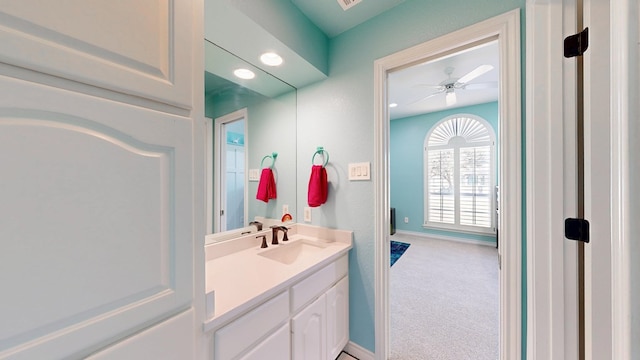 bathroom with a ceiling fan, recessed lighting, vanity, and baseboards