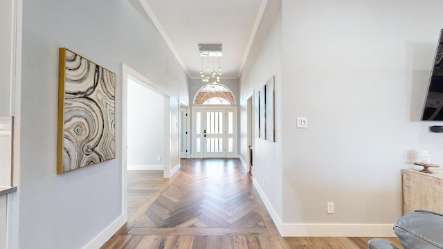 doorway featuring ornamental molding and baseboards