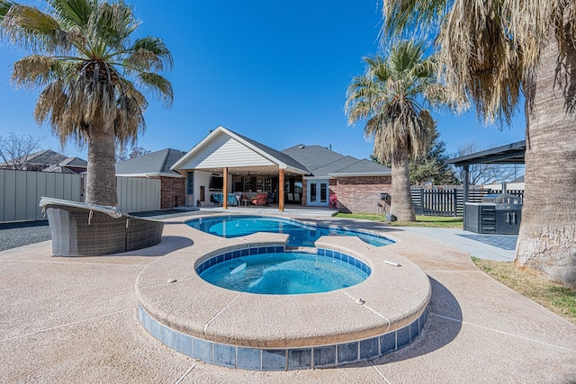 view of pool featuring a fenced in pool, an in ground hot tub, fence, french doors, and a patio area